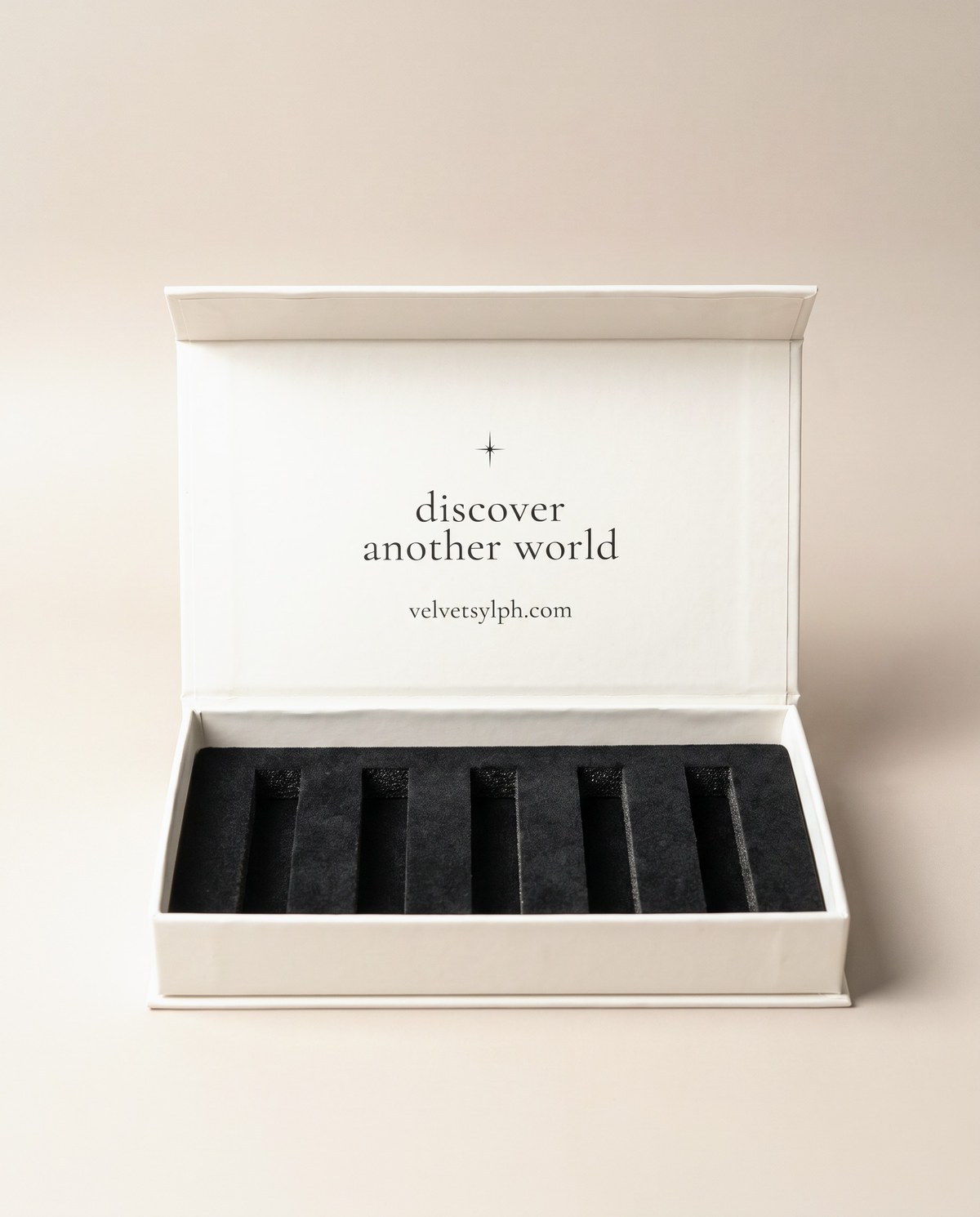 The Discovery Set open, the lid reading discover another world above five slots for 5 mL vials